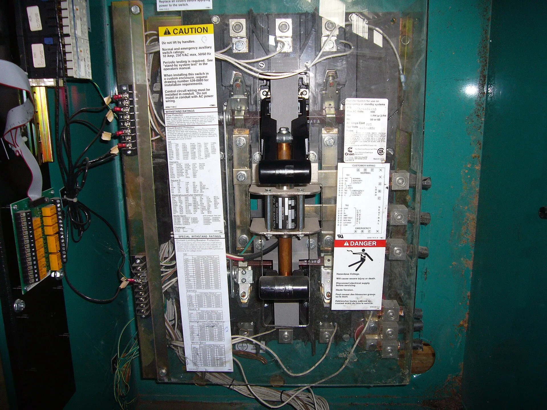 Automatic transfer switch installed next to an electrical panel in Henderson County, North Carolina